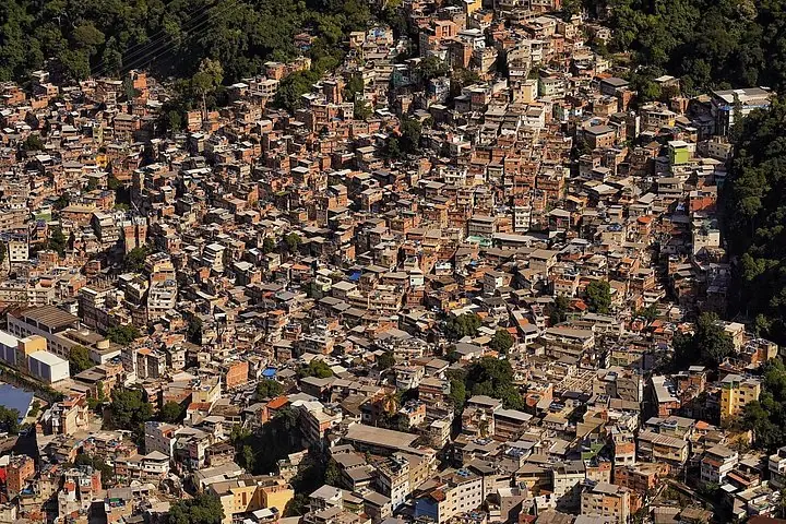 Aerial view of a densely populated favela on a hillside.